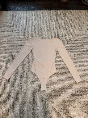 Long Sleeve Open Back One-Piece Bodysuit in Nude
